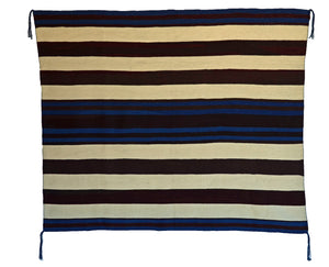 A Navajo Chief blanket with a geometric pattern featuring stripes in various colors including blue and brown.