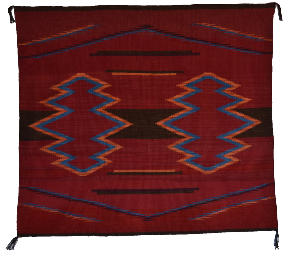 Woman's manta, cochineal red with orange and blue diamonds.