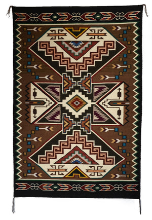 Teec Nos Pos Native American patterned rug with geometric design on a brown background.