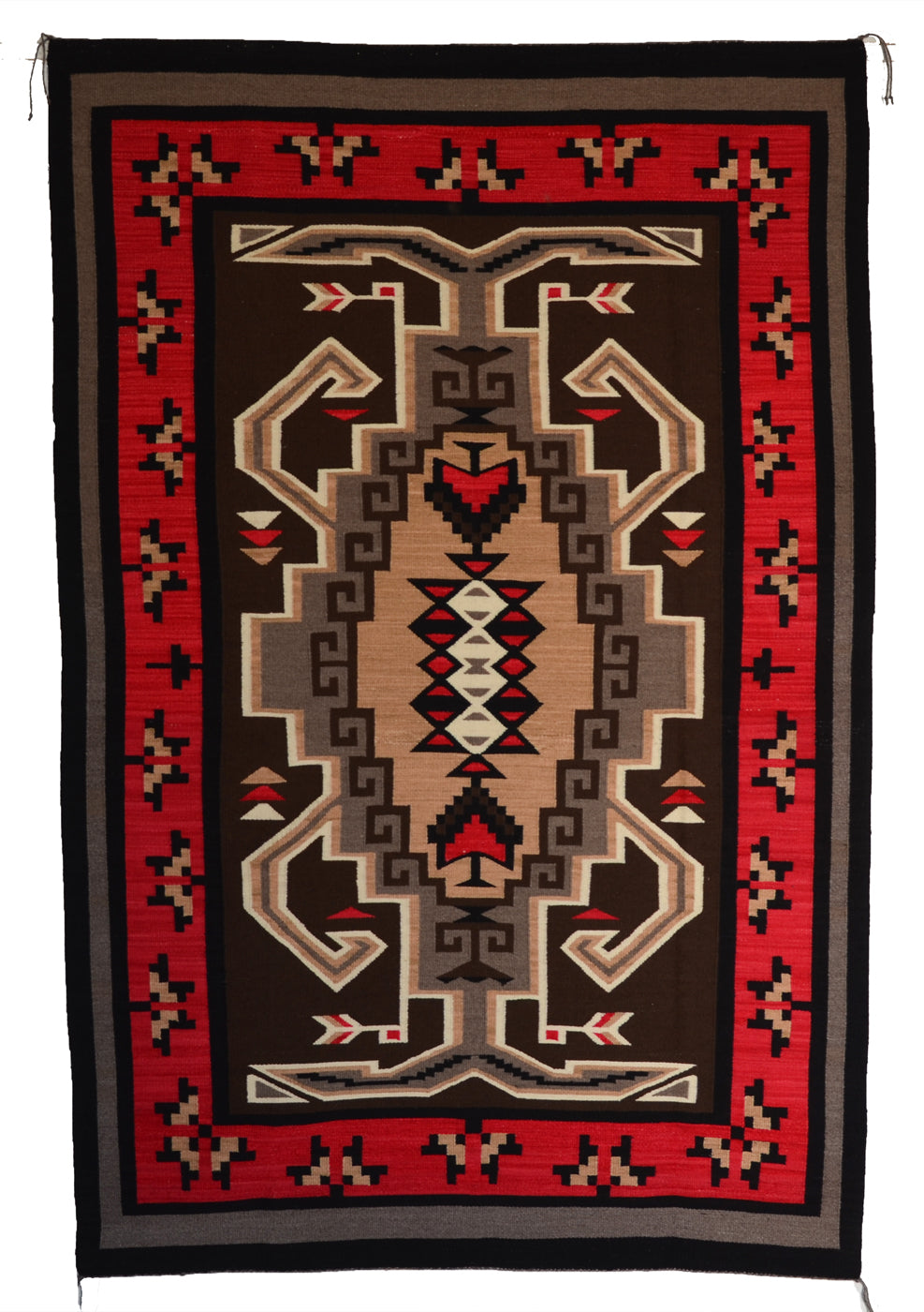 Hero Twin Crystal Navajo rug with geometric patterns on a red and brown background.